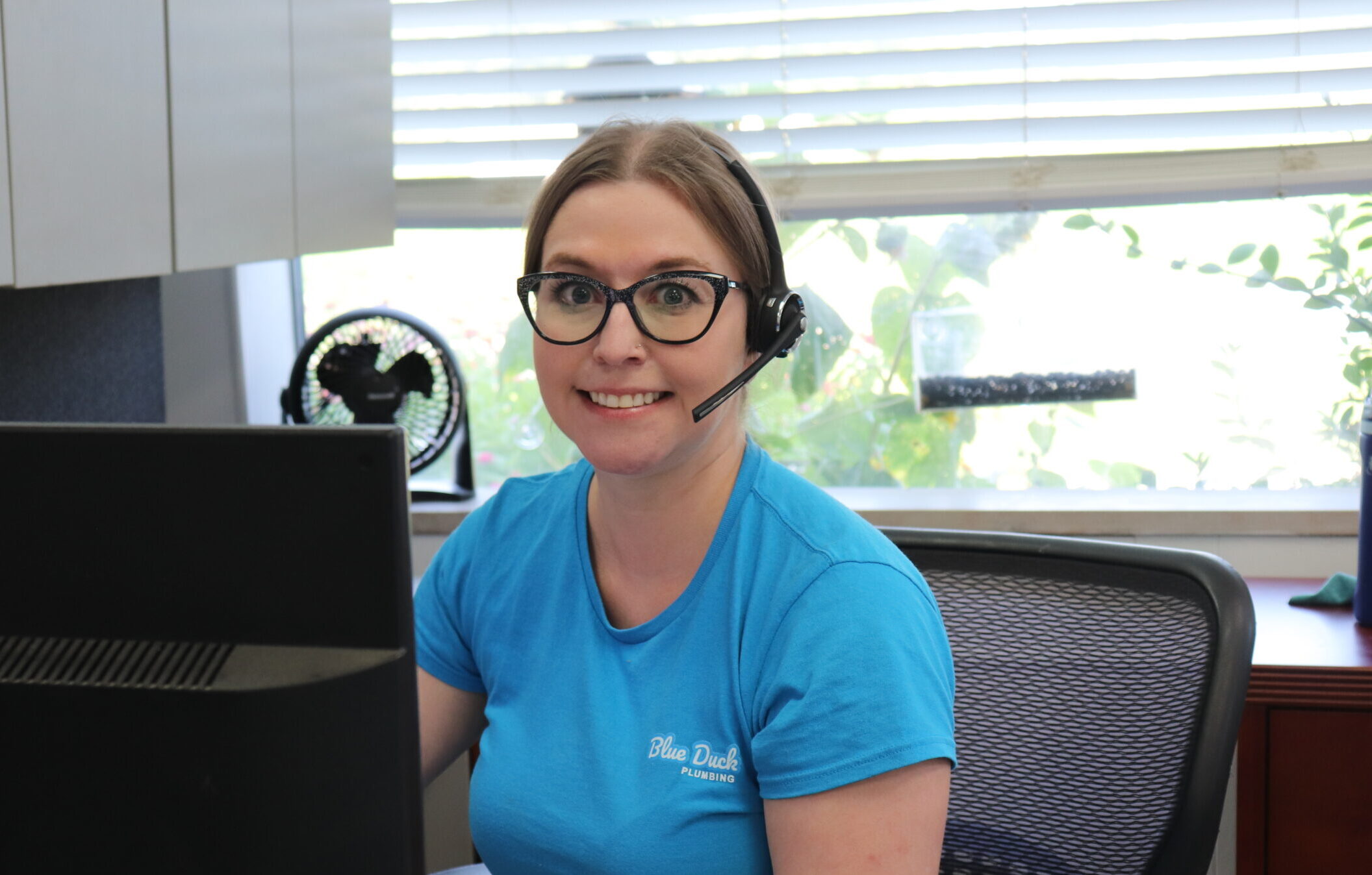 An employee answering the phone, smiling